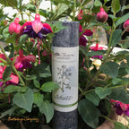 Schutz, Ritualkerze der Allgäuer Heilkräutermanufaktur, Farbe Schwarz, zwischen Blumen